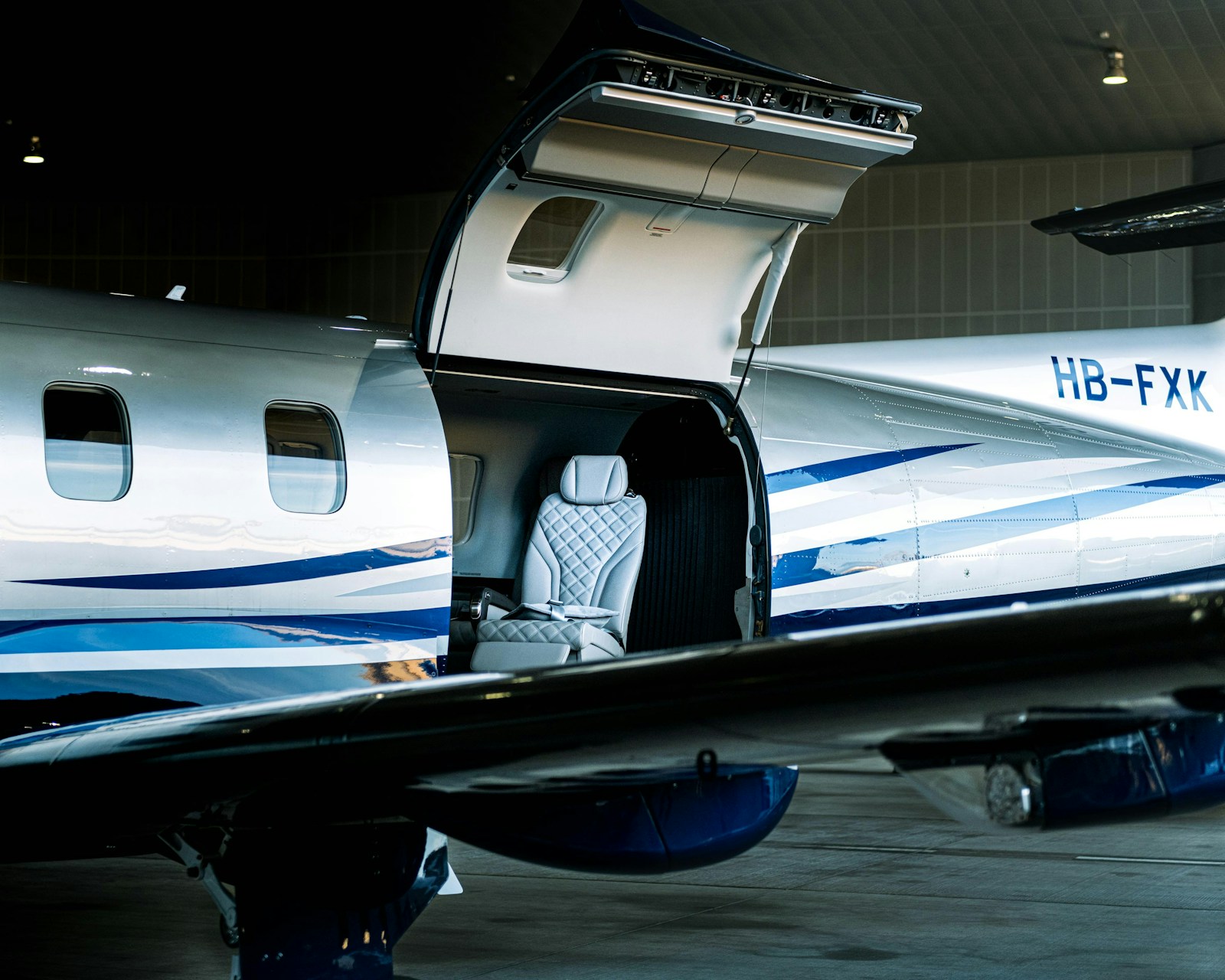 Pilatus PC-12 with cabin door open in a hangar